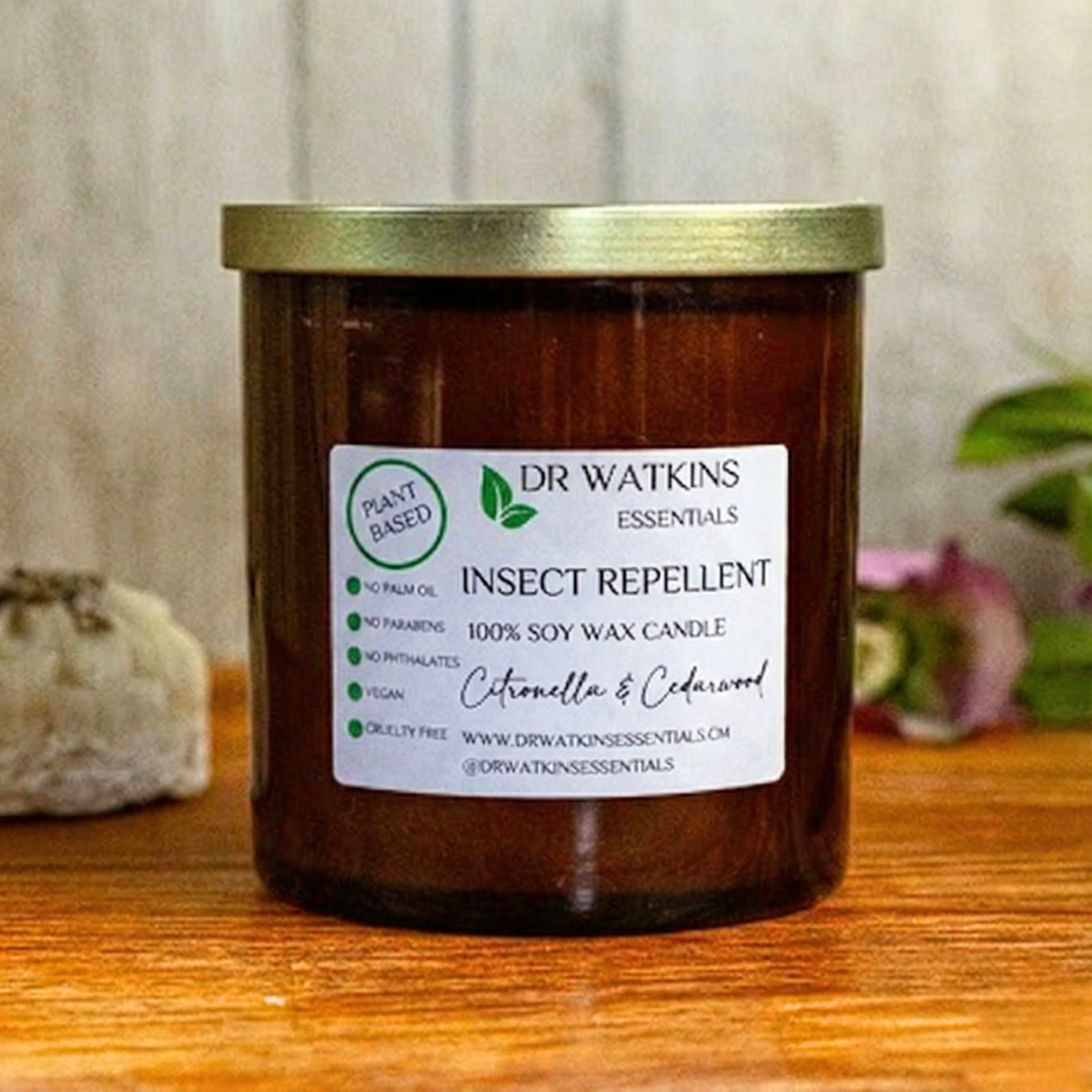 Insect repellent candle with a label on a wooden surface